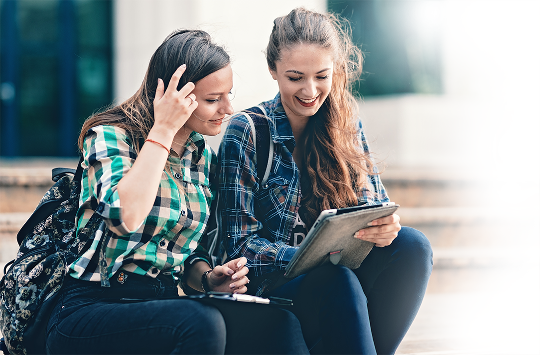 2 girls looking at a tablet