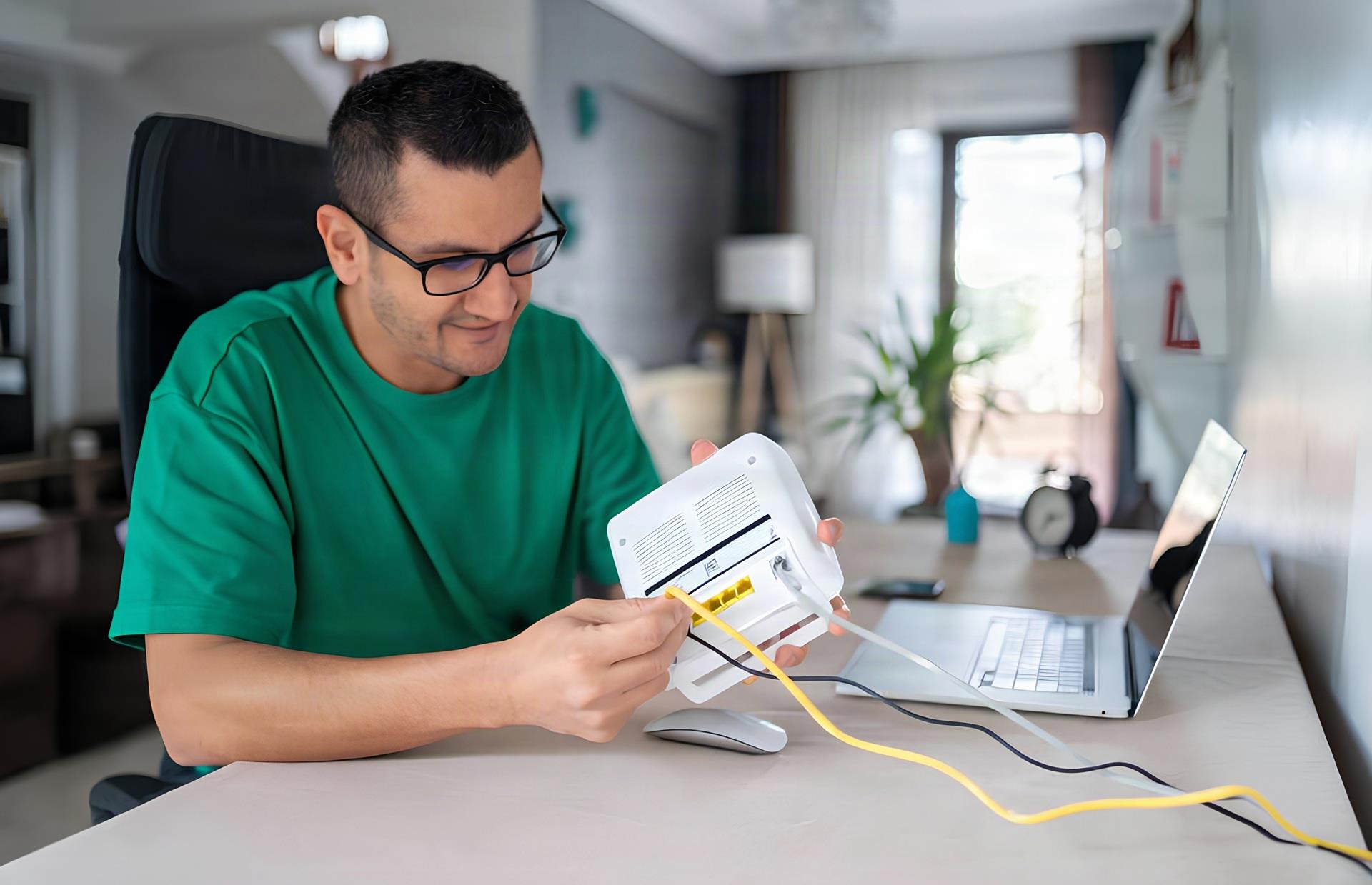 Man adjusting his Wi-Fi router placement at home for faster, more reliable internet