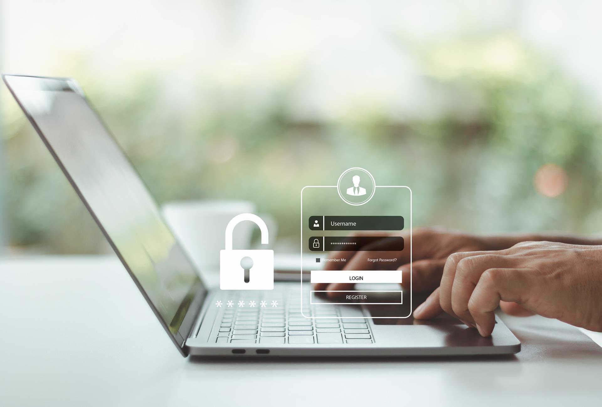 Hands typing on a laptop with a secure login screen and padlock icon for strong passwords